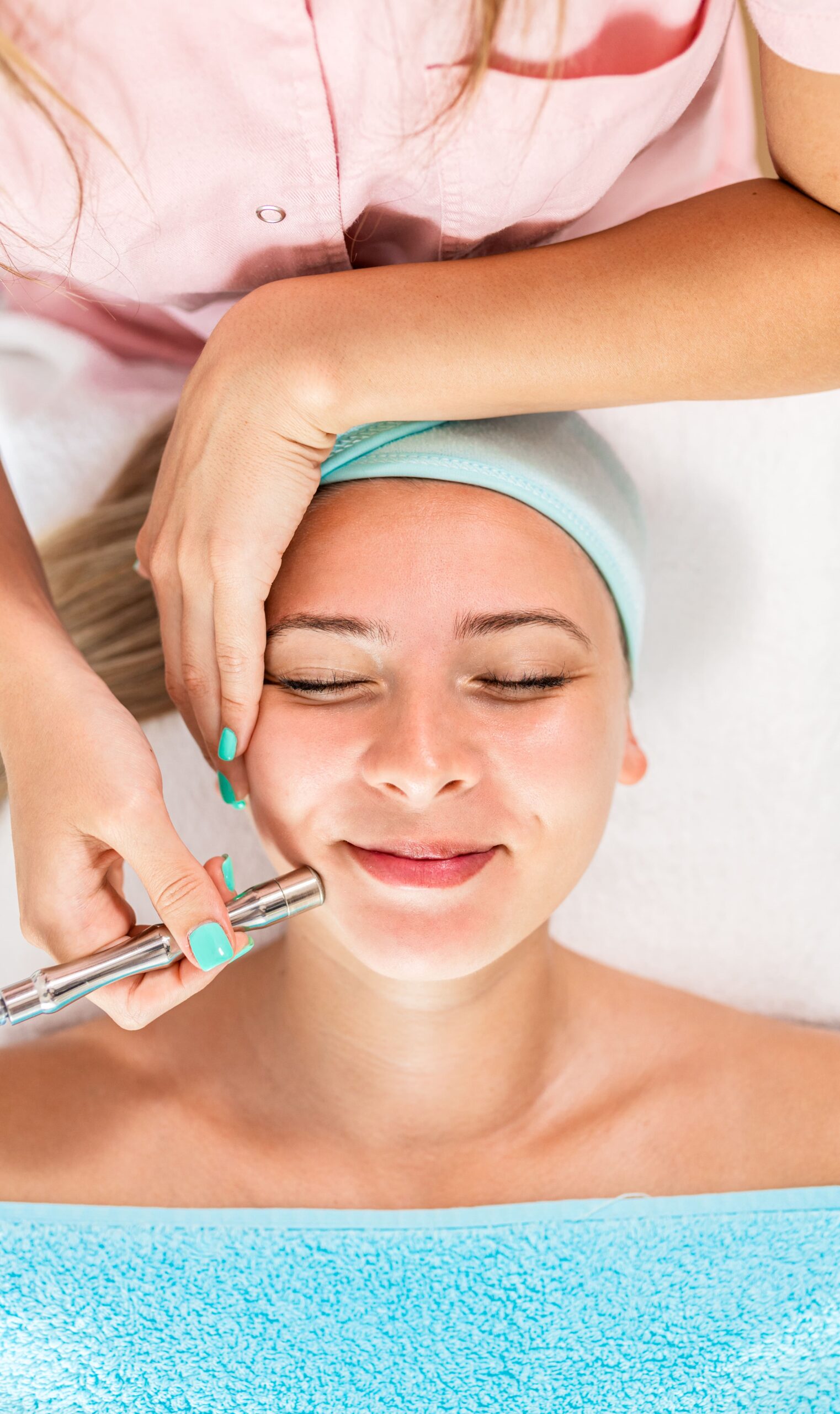 beautician-therapist-applying-face-treatment-in-be-2025-01-30-05-37-43-utc-min Beautician therapist applying face treatment in beauty salon to young woman.
