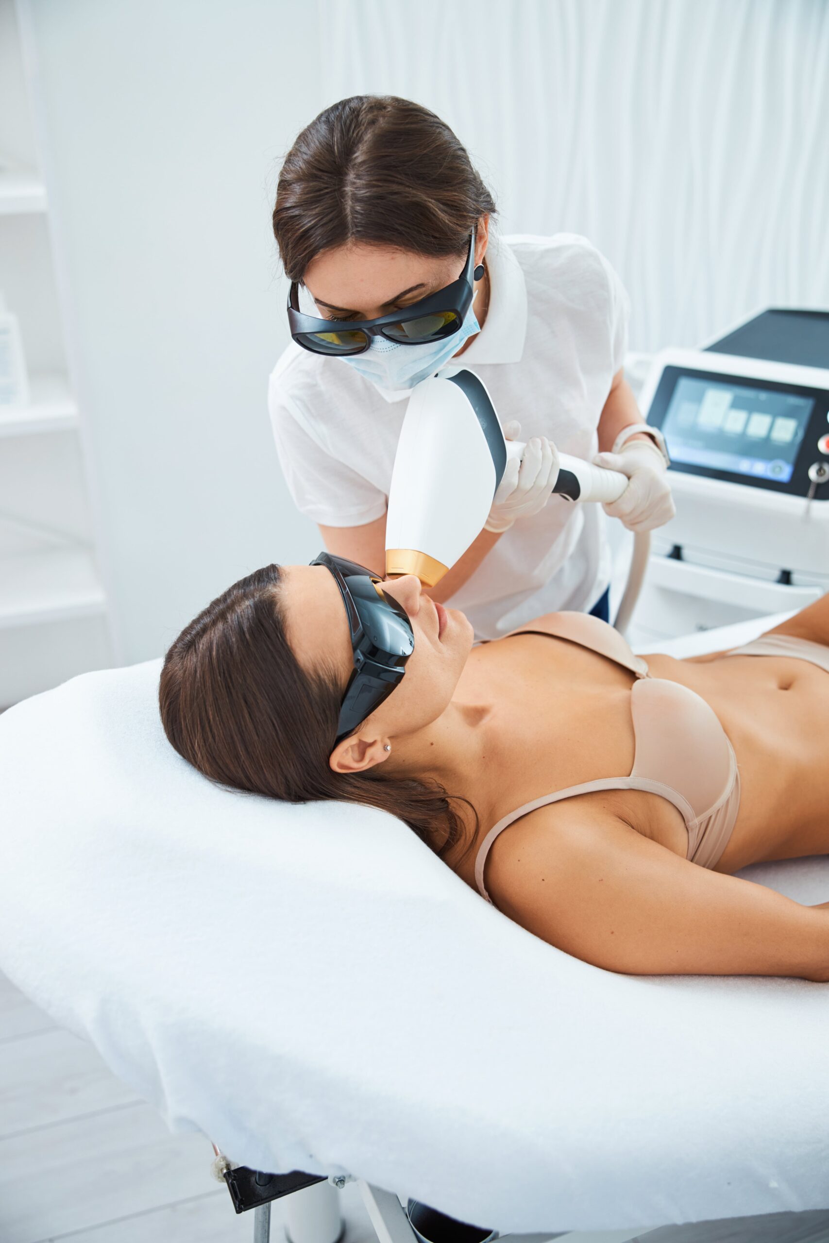 Cosmetologist performing an upper lip laser hair removal procedure