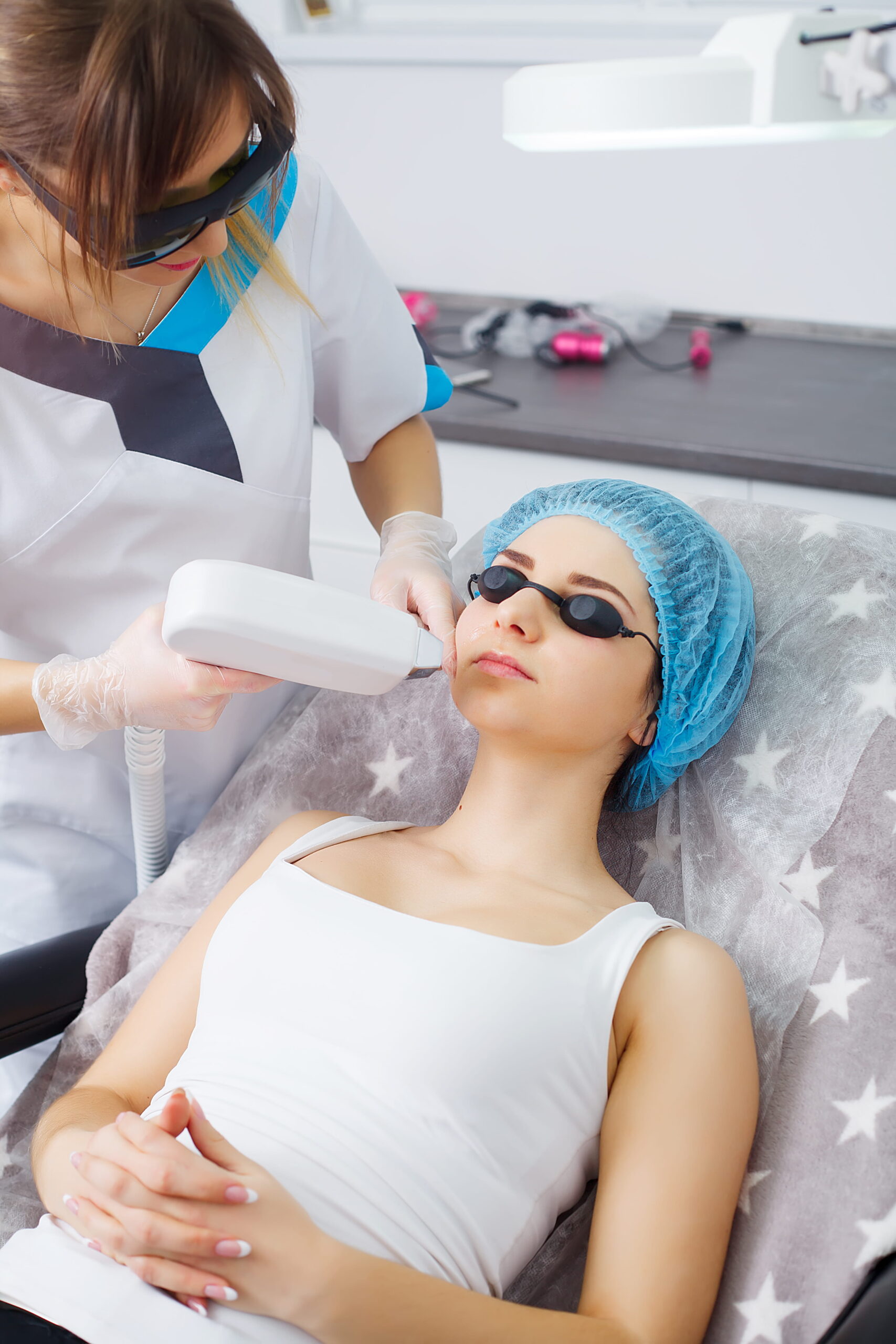 Woman Receiving Facial Laser Treatment at Clinic