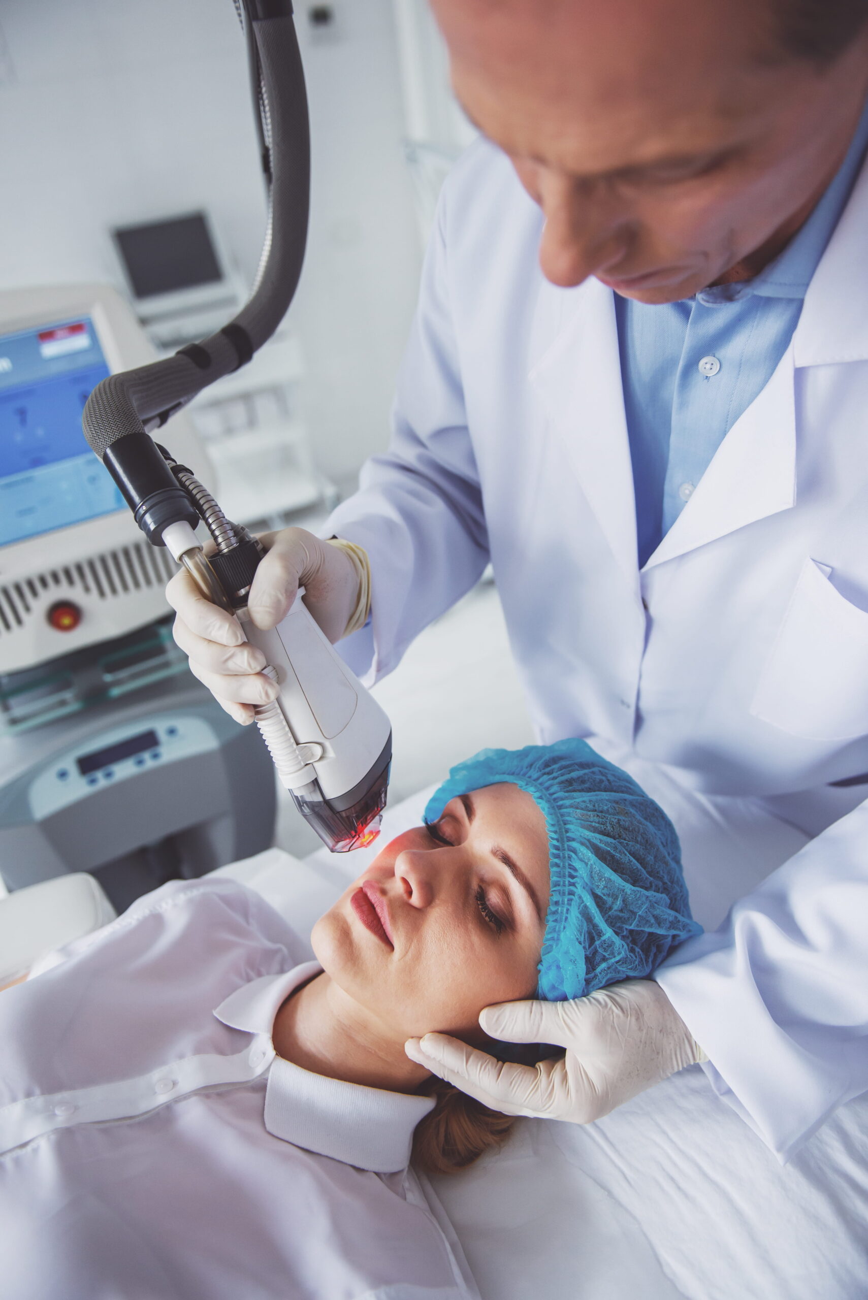 Woman Receiving Laser Treatment from Doctor in Clinic